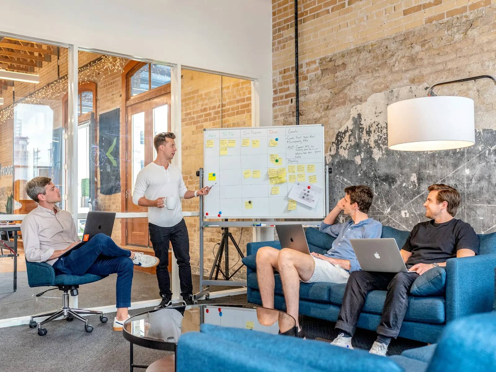 Founder presenting the product idea on a whiteboard to the team