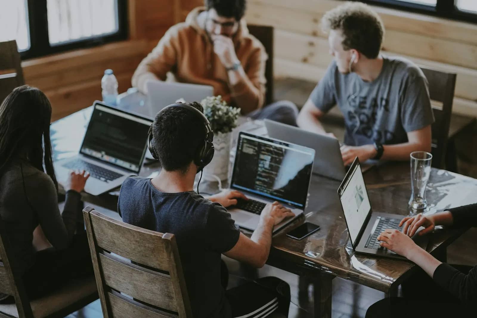 Small startup team coding together around a table