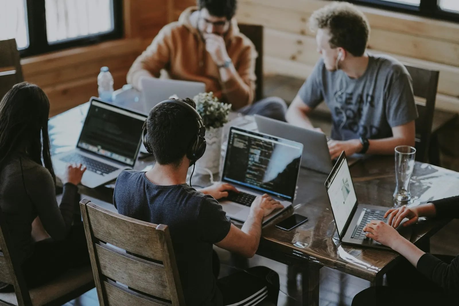Small startup team coding together around a table
