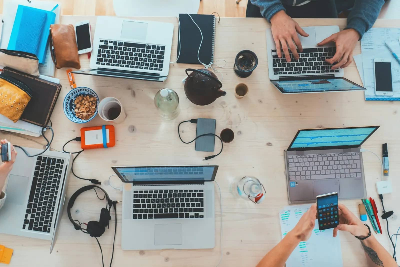 Scale-up delivery team at work across laptops and phones