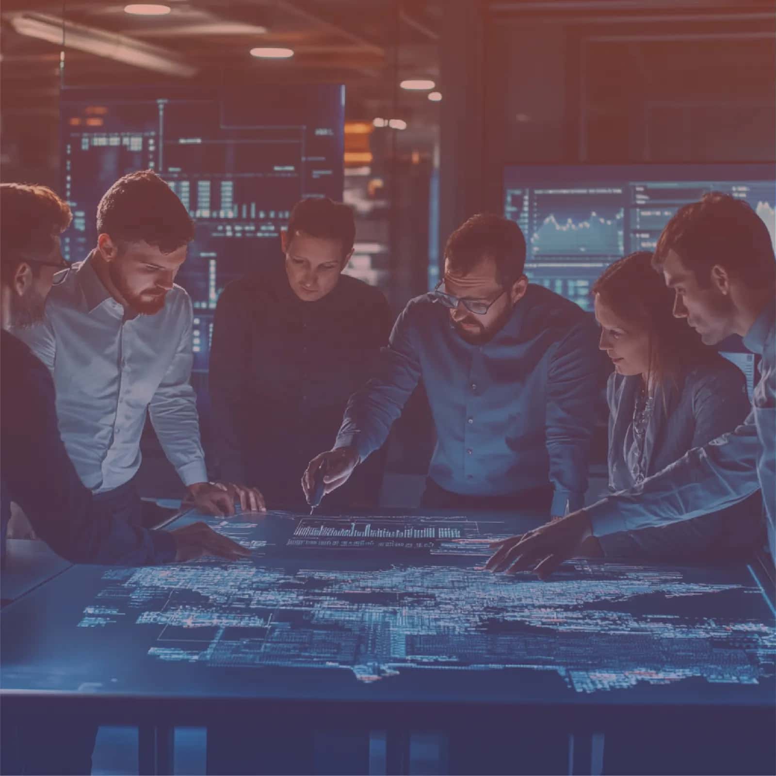 Team reviewing system data flows on a shared dashboard table