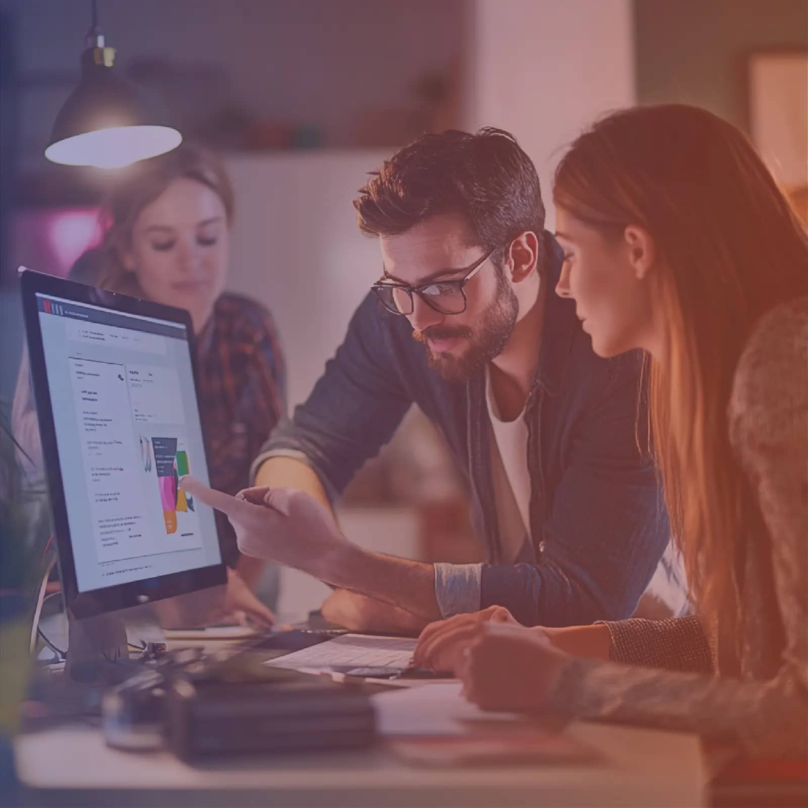 Designer and product owner reviewing an interface prototype on screen